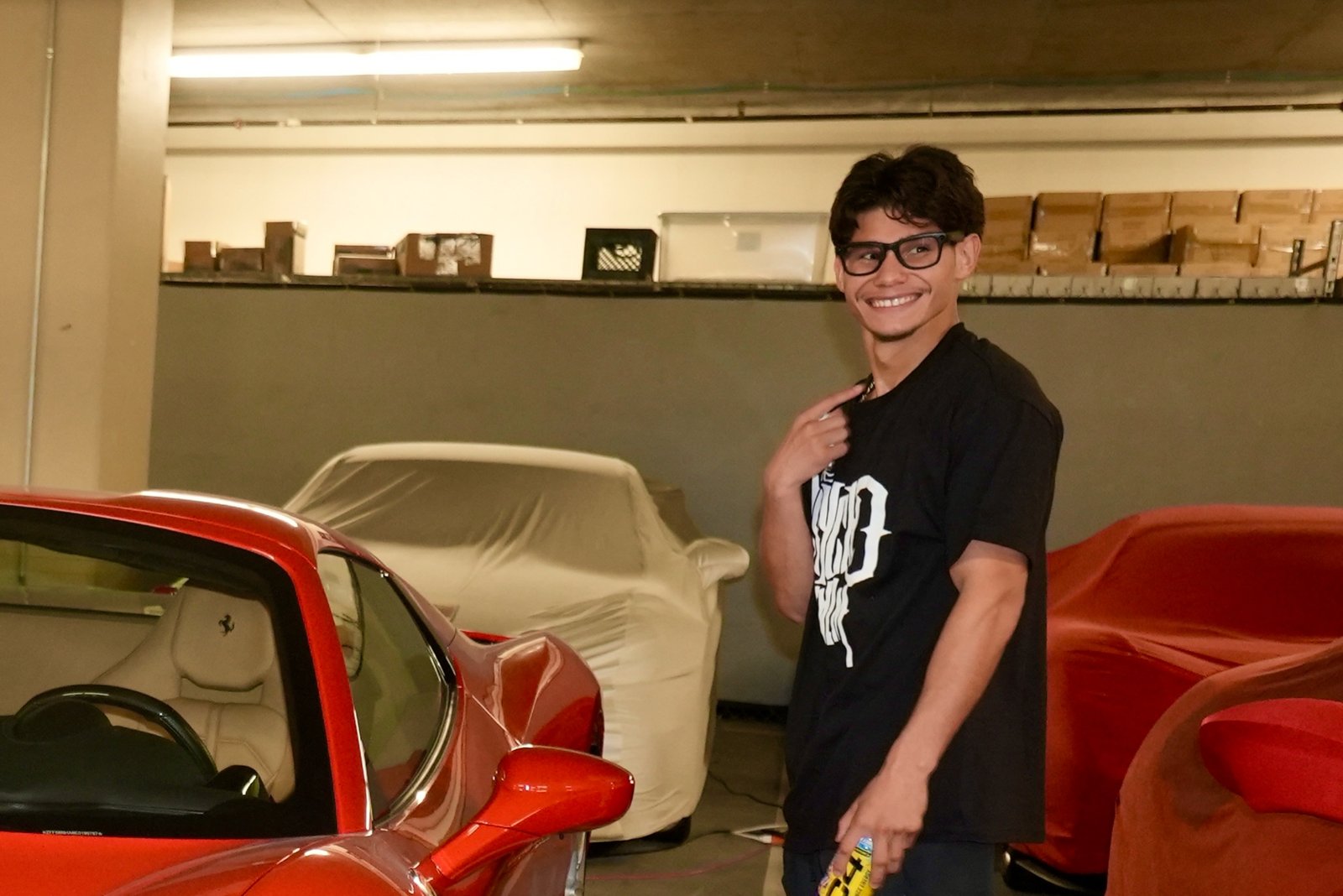 Amador Mendez smiling in a car garage